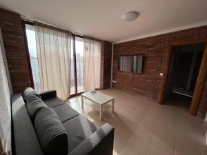 a living room with a couch and a table at APARTAM GRANOLLERS in Granollers