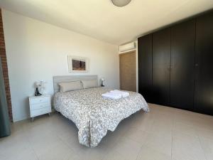 a bedroom with a bed and a dresser in it at APARTAM GRANOLLERS in Granollers