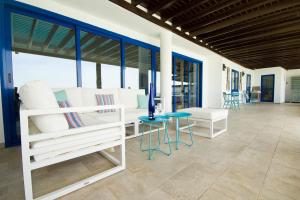 una camera con letti bianchi e tavolo e sedie di Villa Lucy - By AZ Rentals a Puerto del Carmen