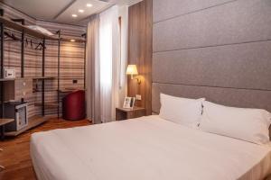 a bedroom with a large white bed in a room at SIRIOHotel in Dormelletto +90 photos