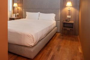 Postel nebo postele na pokoji v ubytování SIRIOHotel