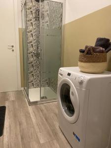 a washing machine in a bathroom with a shower at La Casa di Mimmi in Mantova