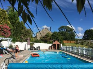 a child playing in a pool in a backyard at Dozmary Cottage in Launceston
