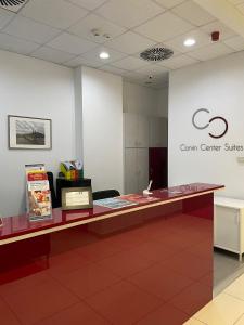 a reception desk in a room with a sign on the wall at Corvin Center Suites in Budapest