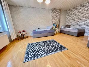 a living room with two beds and a rug at KobyHome Apartment in Enger