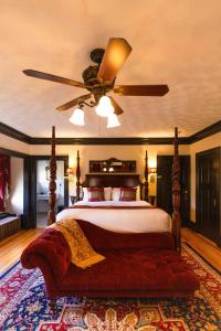 a bedroom with a bed with a ceiling fan at Manor House Inn in Norfolk
