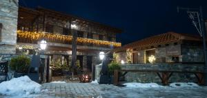 a building with christmas lights on it at night at kaimak luxury chalet in Palaios Agios Athanasios