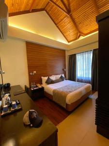 a bedroom with a large bed in a room at The Golkonda Resort and Spa in Hyderabad