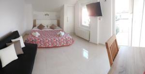 a white room with a bed and a couch at Guesthouse Cecilia in Malinska +81 photos