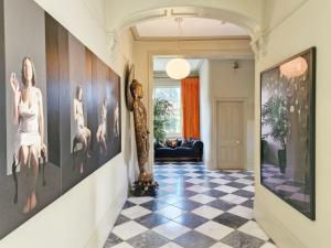 einen Flur mit Kunst an den Wänden und einem karierten Boden in der Unterkunft Blythe House - Emsworth in Emsworth