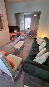 a living room with two couches and a table at Jasper's by Spires Accommodation a great base to stay for Alton Towers and corporate clientele working away from home in Stoke on Trent