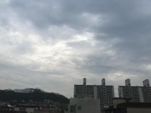 a city with tall buildings and a cloudy sky at I House Chinchin in Seoul