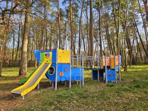 a group of playground equipment in a park at Ośrodek Wypoczynkowo-Szkoleniowy Perkoz in Krynica Morska