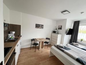 a kitchen with a table and chairs in a room at Low Budget Apartment Cologne in Cologne