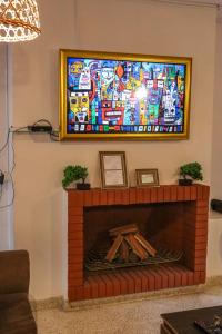a living room with a fireplace with a tv above it at Renty Paraguay in Asuncion