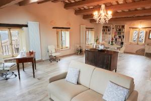 a living room with a couch and a table at Dimora nel Castello di Loretello in Loretello