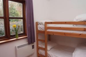 a bedroom with two bunk beds and a window at Siblyback Cottage in Launceston