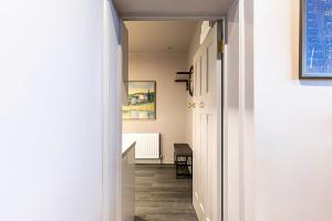 a hallway with a stairway leading to a room at Stunning 5 Bed House in Willesden Green! in London