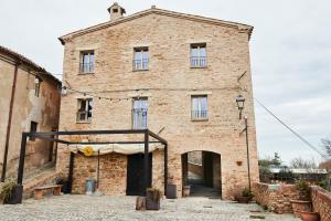 a large brick building with a tent in front of it at Dimora nel Castello di Loretello in Loretello