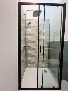 a shower with a glass door in a bathroom at Stylish newly renovated apt feels like second home in Bucharest +14 photos