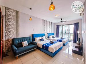 a bedroom with two beds and a couch at Teega Suites by JBcity Home in Nusajaya