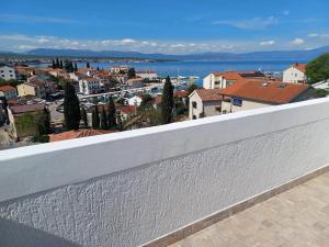 a view of a city from the balcony of a house at Guesthouse Cecilia in Malinska