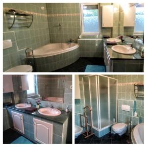 een badkamer met 2 wastafels, een bad en een toilet bij bellavitavilla2020 in Siófok
