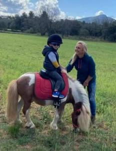 a woman and a child riding on a horse at Chambre in Jouques