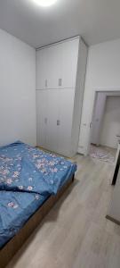 a bedroom with a bed and white cabinets at New Luxury 1st Story with balcony - 3 rooms 1 bathroom kitchen tv-wifi -city in Ferizaj