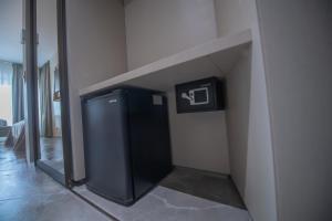 a small refrigerator in the corner of a room at Hotel Atena*** in Saturn