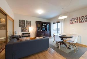 a living room with a blue couch and a table at GuestReady - Memories House - Art Quartier in Porto