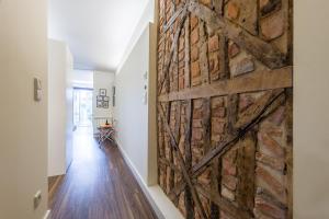 a sliding barn door in a hallway with a brick wall at GuestReady - Flat59 Terrace in Porto