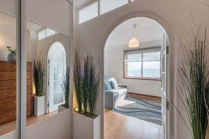 a hallway with an archway and a living room at GuestReady - Porto Magic View in Bandeira