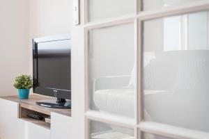 a bedroom with a mirror and a television on a table at GuestReady - Porto Magic View in Bandeira