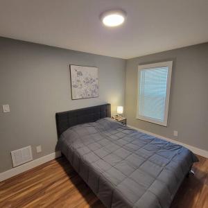 a bedroom with a bed and a window at Walk to Niagara Falls. Renovated 3 bed house! in Niagara Falls
