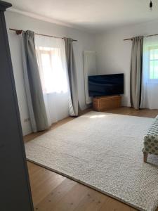 a living room with a rug and a window at Am Schafhof in Velburg