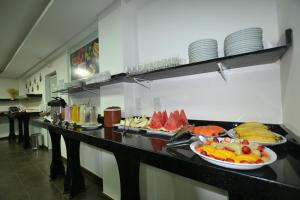 a buffet in a restaurant with plates of food at Hotel Desbravador in Chapecó