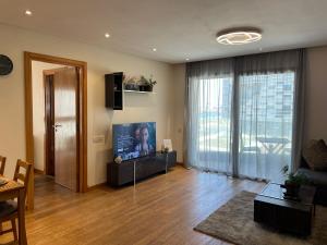 a living room with a couch and a tv at Brand new, Stylish & Well located Apartment in Casa-Marina 12 in Casablanca