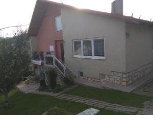a house with a staircase leading to a window at Ubytovanie Poráč in Poráč