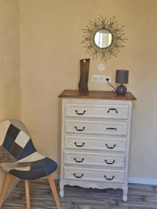 a dresser with a mirror on top of it at Marceline in Molières-Cavaillac +3 photos