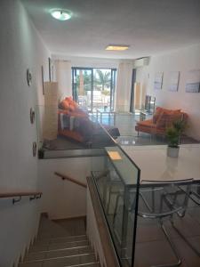 a living room with a glass table and a couch at Club Del Mar No.8 in Puerto del Carmen