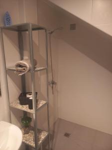 a bathroom with a shelf under a stairs at Club Del Mar No.8 in Puerto del Carmen