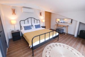 a bedroom with a large bed and a desk at The Vera Residence in Fethiye