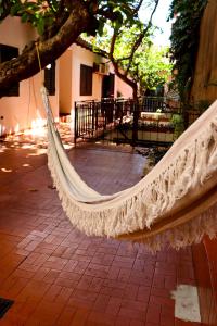 a hammock hanging from a tree on a sidewalk at Renty Paraguay in Asunción