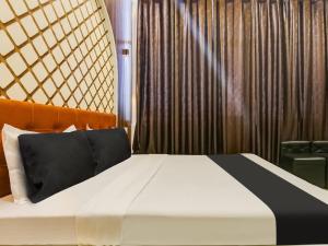Кровать или кровати в номере OYO Hotel Green In