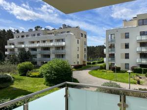 a balcony with a view of two buildings at Apartment Platinum in Międzyzdroje