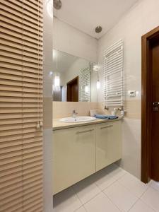 a bathroom with a sink and a mirror at Apartment Platinum in Międzyzdroje