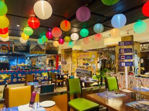 a restaurant with colorful lanterns hanging from the ceiling at Crowne Plaza New Delhi Okhla, an IHG Hotel in New Delhi