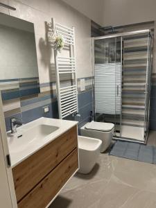 a bathroom with a sink and a toilet at Alysia House in Naples