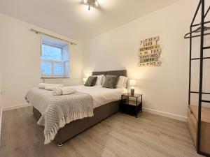 a bedroom with a bed and a window at Modern~ Reverse Level~2 bed~Townhouse~Central~Penzance in Penzance